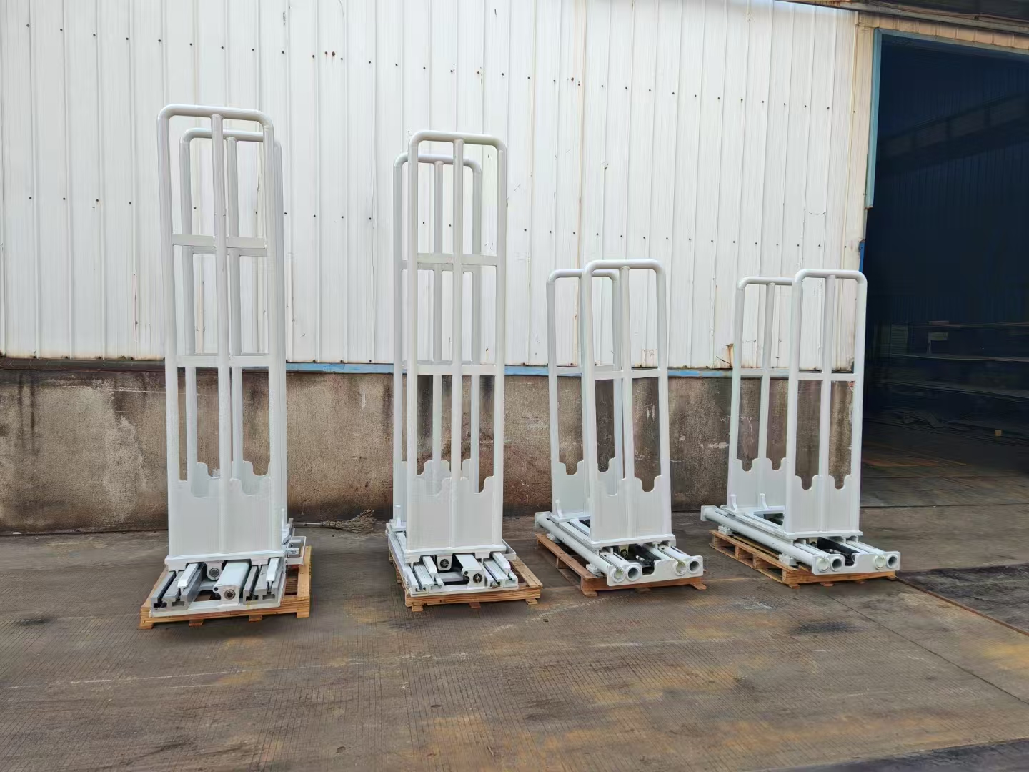 Multiple forklift clamp attachments prepared for different load sizes